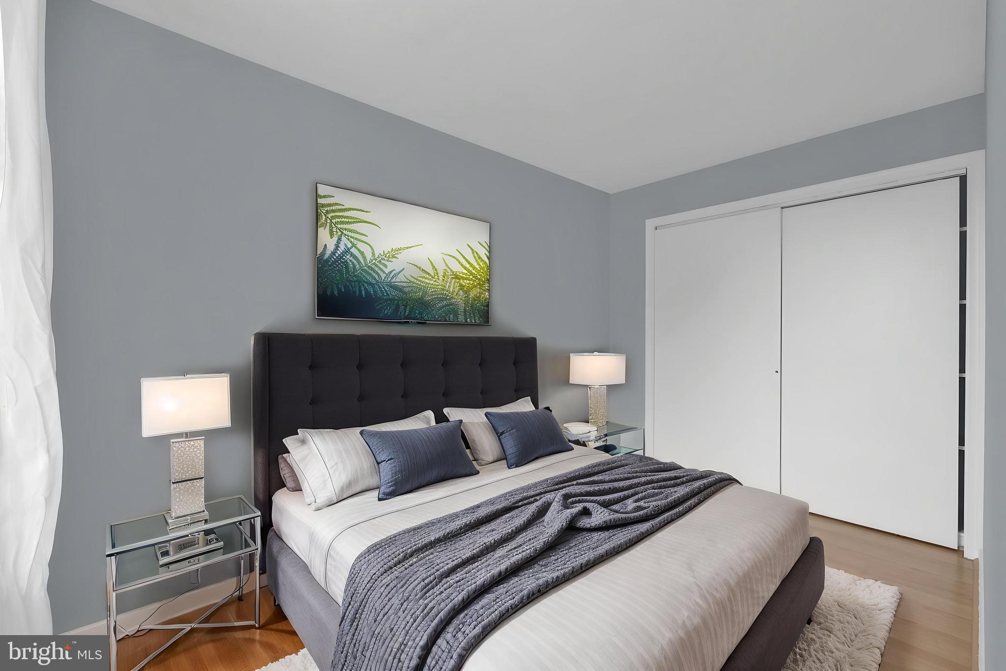 1245 4th Street Southwest, Unit E210 Washington, DC 20024 - Photo 9 of 28 a bedroom with bed and a potted plant