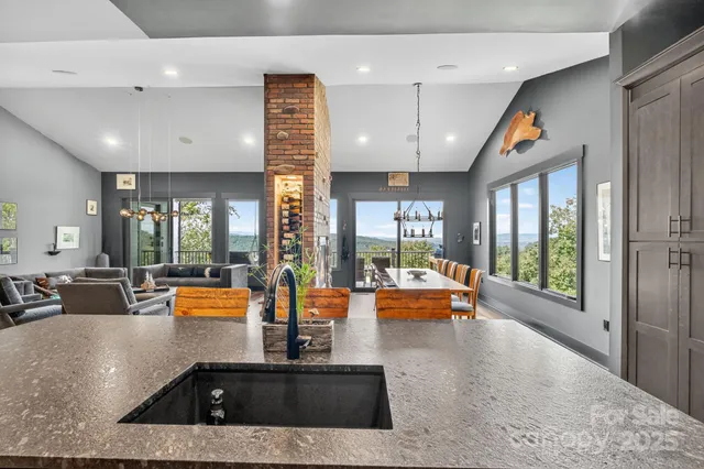 a living room with furniture or couch and a chandelier