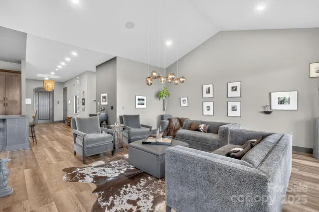 a view of a dining room with furniture large windows and wooden floor