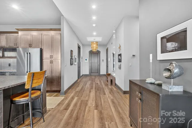 a view of a hallway with wooden floor