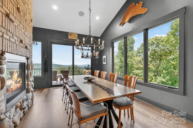 a view of a dining room with furniture large windows and wooden floor