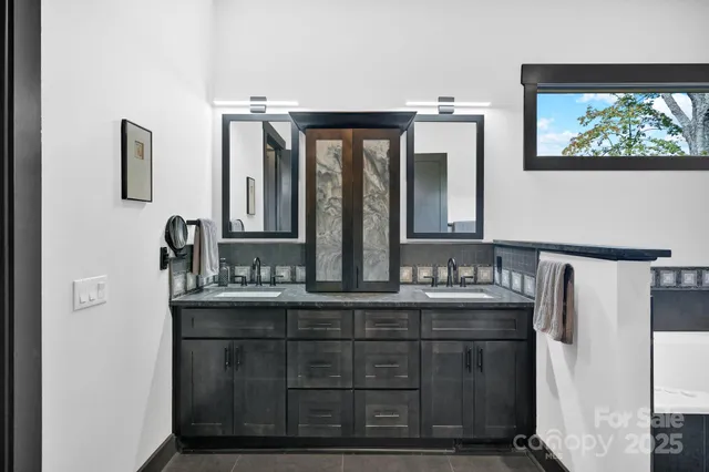 a bathroom with a double vanity sink and mirror