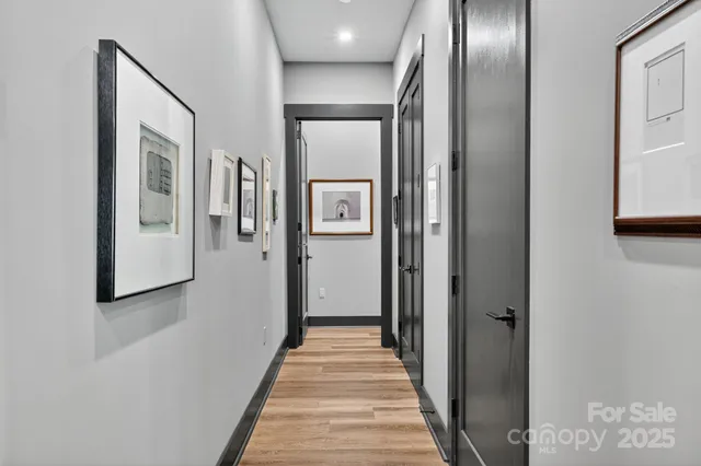 a view of a hallway with wooden floor