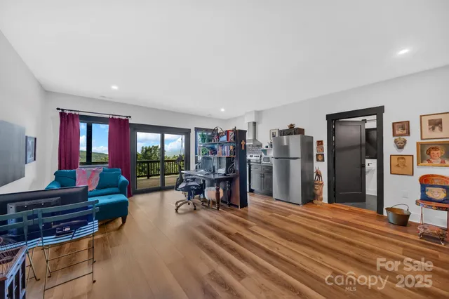 a living room with furniture a window and a table