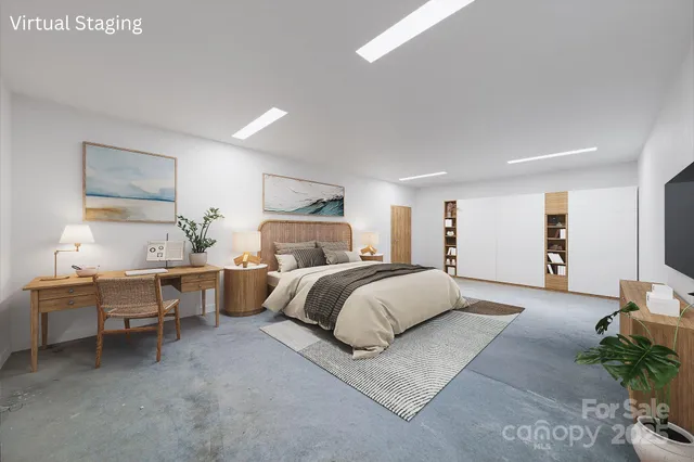 a spacious bedroom with a bed and a lamp