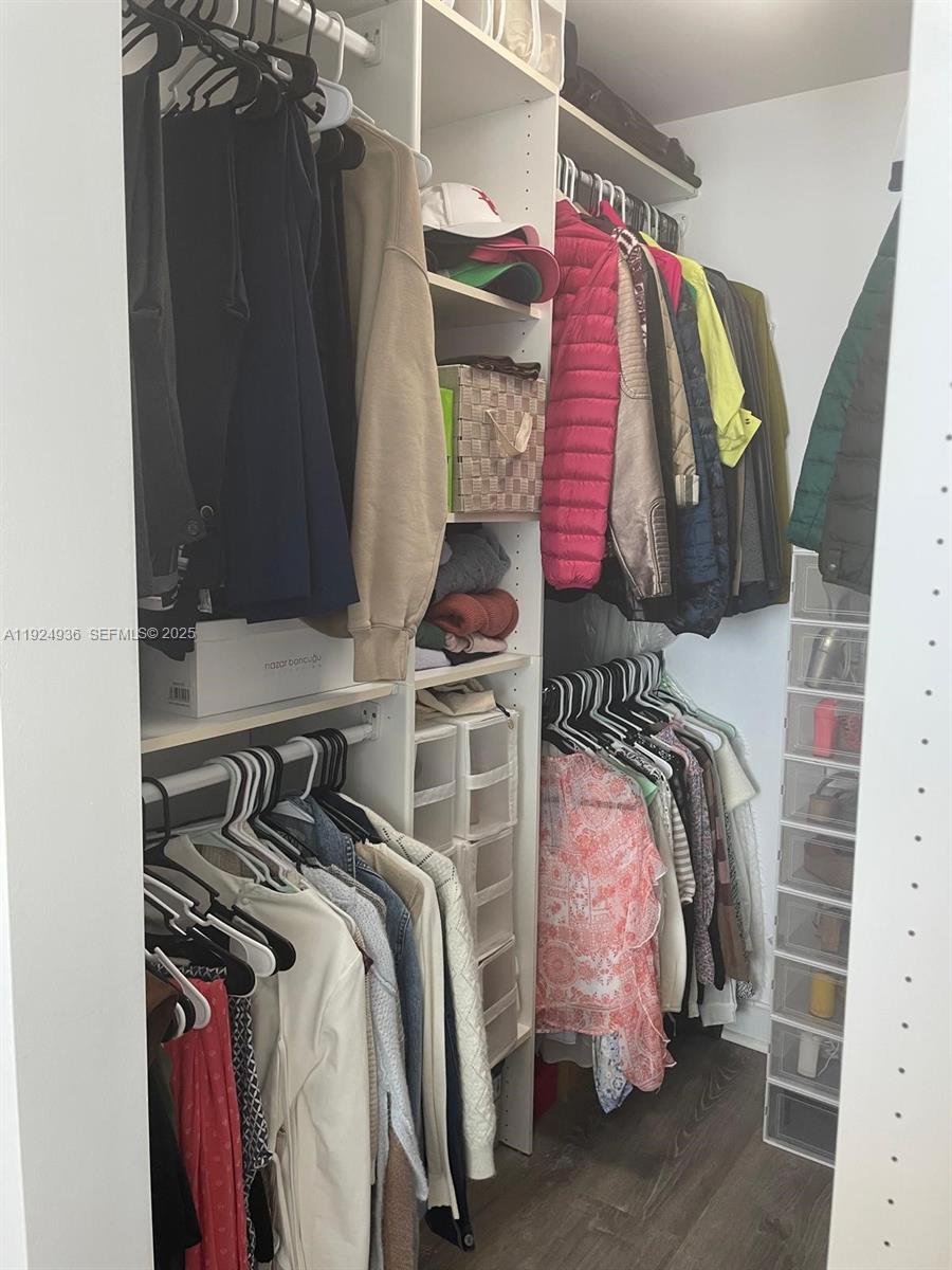 185 Southwest 7th Street, Unit 2014 Miami, FL 33130 - Photo 12 of 38 a view of walk in closet with clothes