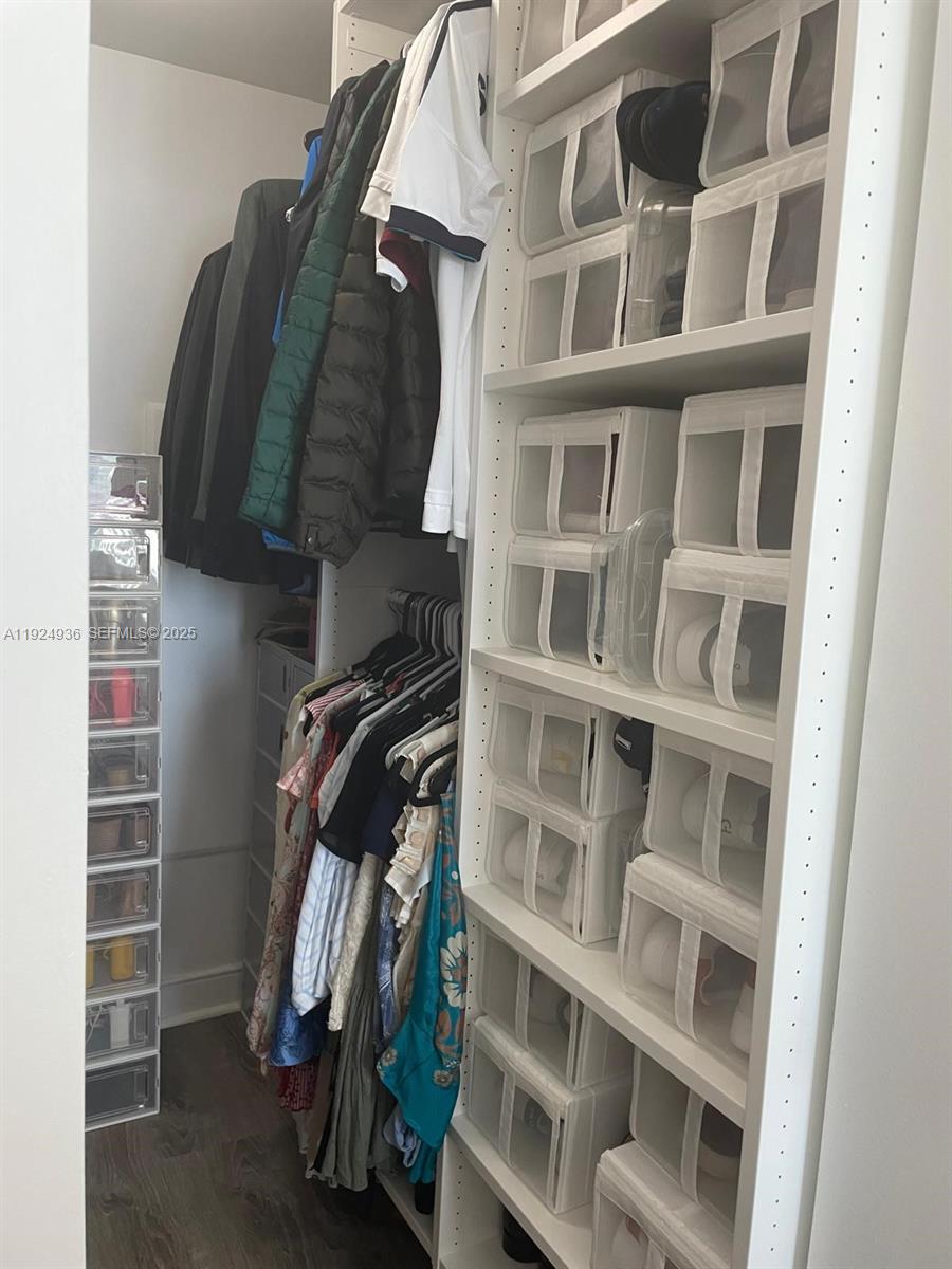 185 Southwest 7th Street, Unit 2014 Miami, FL 33130 - Photo 13 of 38 a view of walk in closet with clothes and shoes