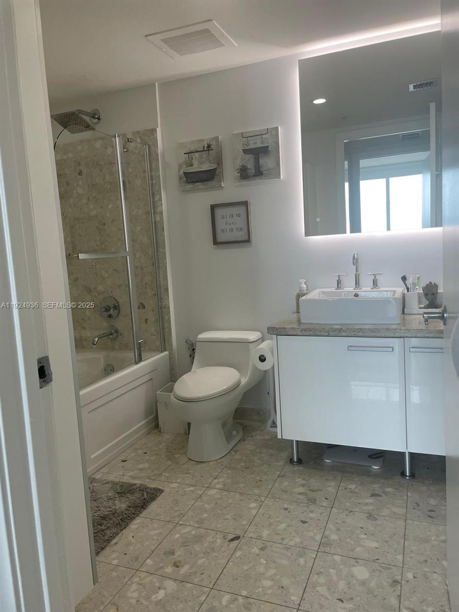 185 Southwest 7th Street, Unit 2014 Miami, FL 33130 - Photo 14 of 38 a bathroom with a sink toilet and shower