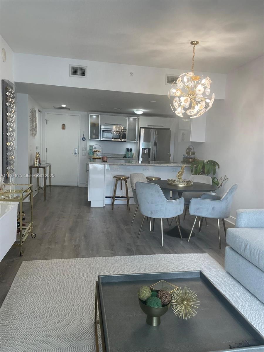 185 Southwest 7th Street, Unit 2014 Miami, FL 33130 - Photo 18 of 38 a living room with dining table and chairs
