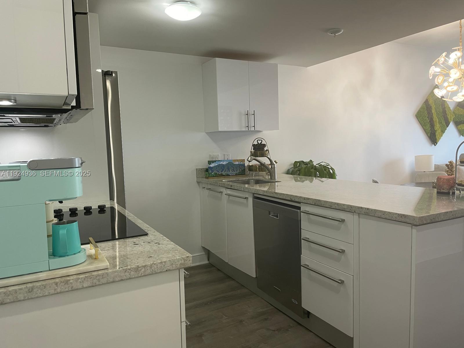 185 Southwest 7th Street, Unit 2014 Miami, FL 33130 - Photo 20 of 38 a kitchen with a sink and cabinets