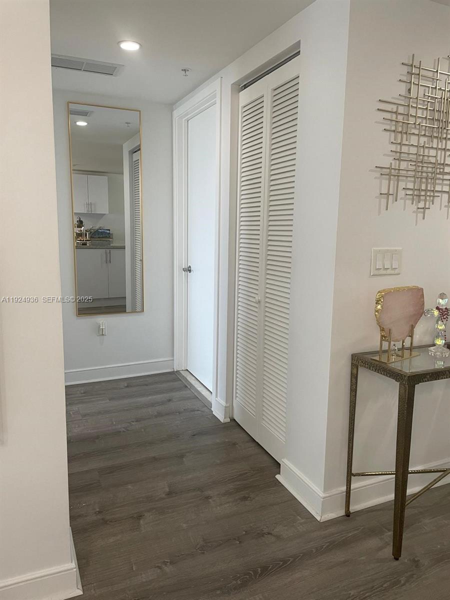 185 Southwest 7th Street, Unit 2014 Miami, FL 33130 - Photo 24 of 38 a view of an entryway of house and livingroom with wooden floor