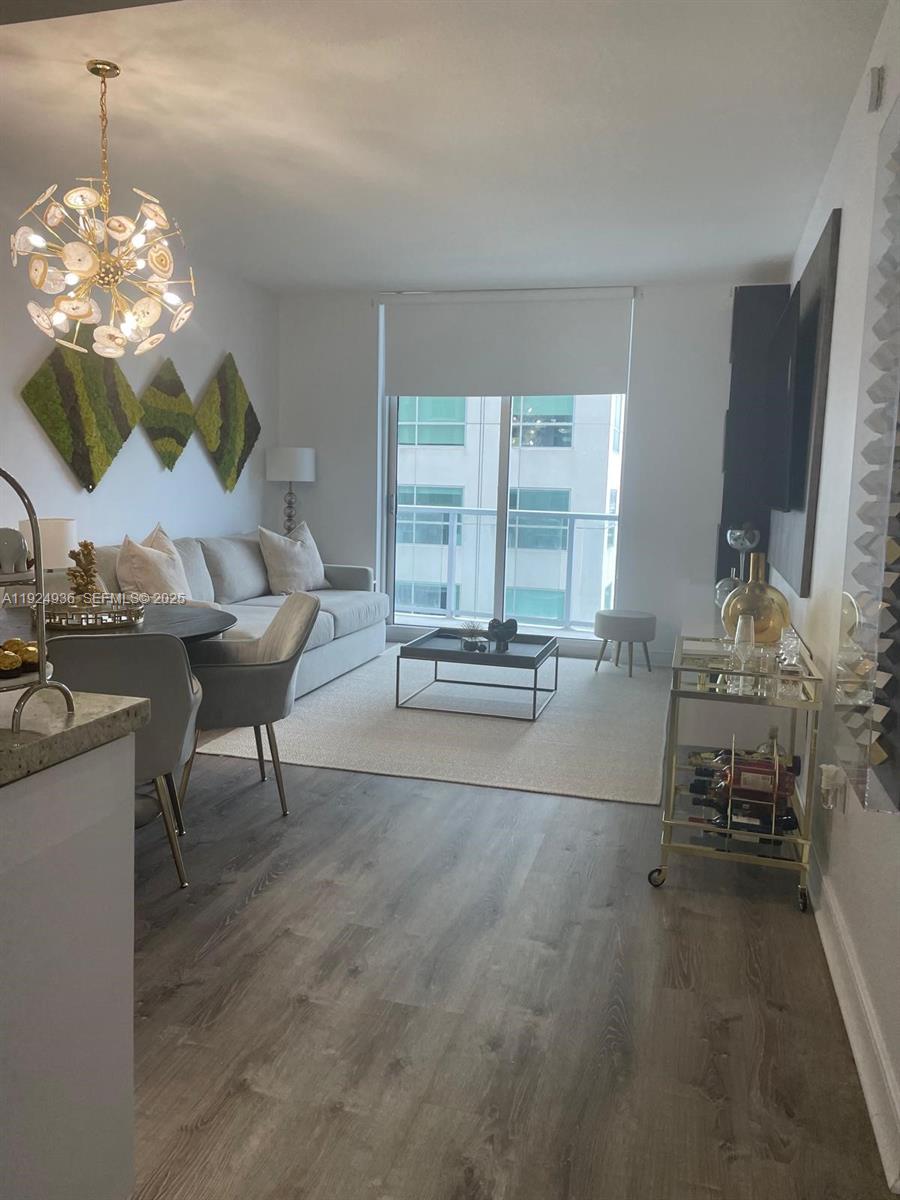 185 Southwest 7th Street, Unit 2014 Miami, FL 33130 - Photo 28 of 38 a living room with furniture and a chandelier