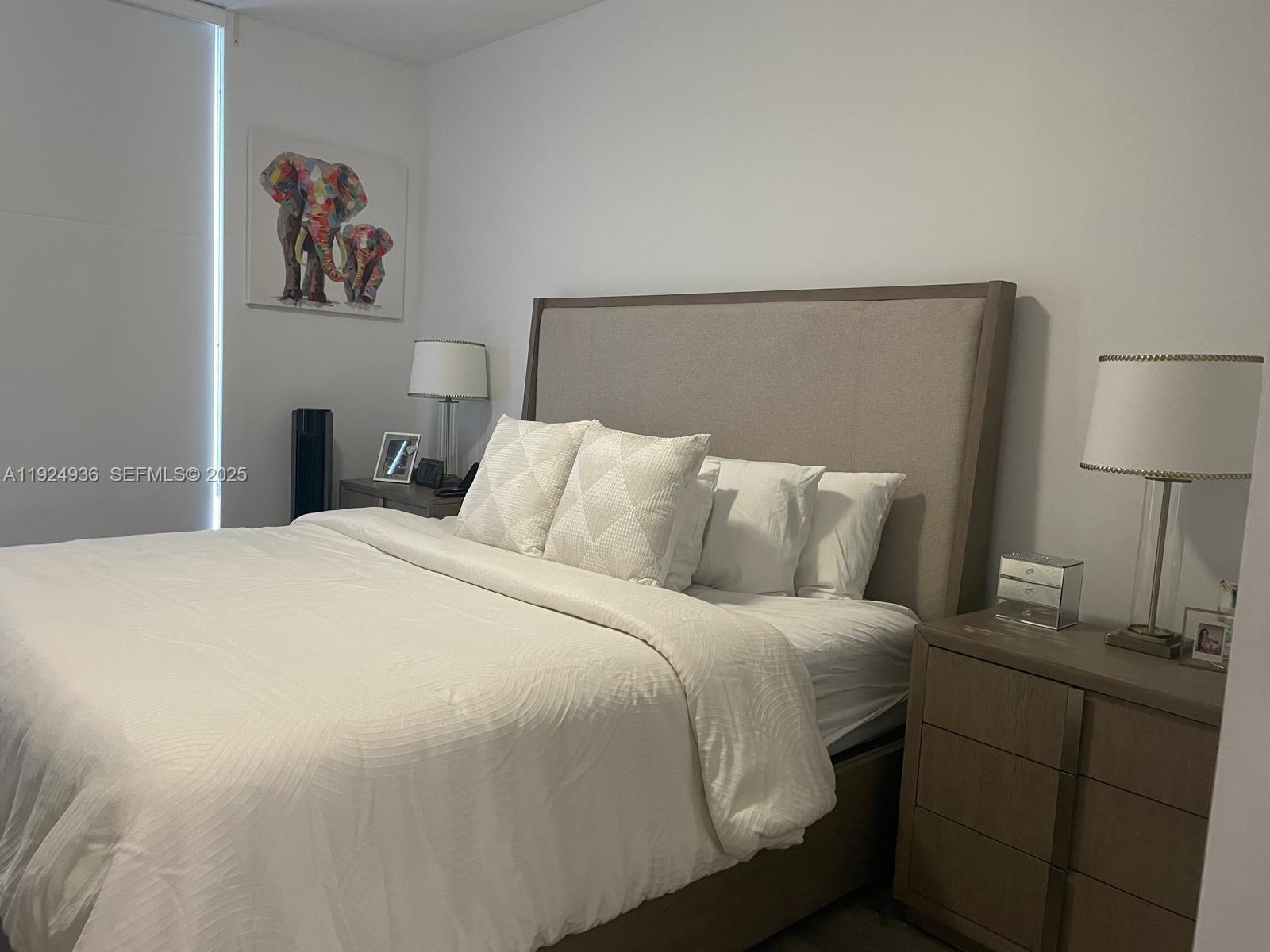 185 Southwest 7th Street, Unit 2014 Miami, FL 33130 - Photo 3 of 38 a bedroom with a bed and a night stand