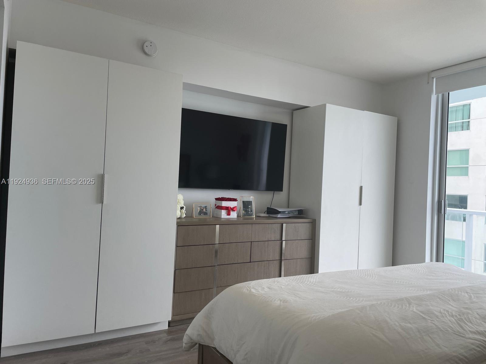 185 Southwest 7th Street, Unit 2014 Miami, FL 33130 - Photo 6 of 38 a bedroom with a bed and a flat screen tv
