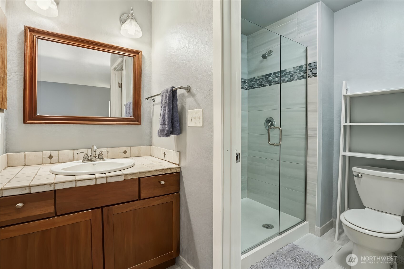 2611 178th Street Southeast Bothell, WA 98012 - Photo 17 of 27 a bathroom with a toilet sink vanity and shower