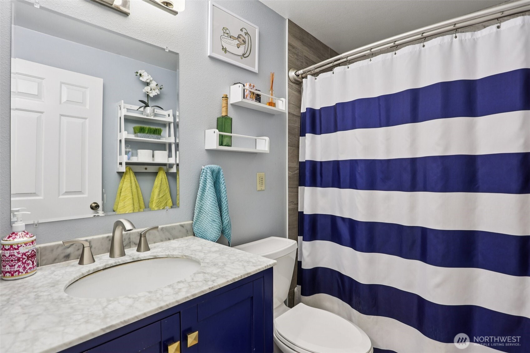 2611 178th Street Southeast Bothell, WA 98012 - Photo 21 of 27 a bathroom with a sink a toilet and shower curtain