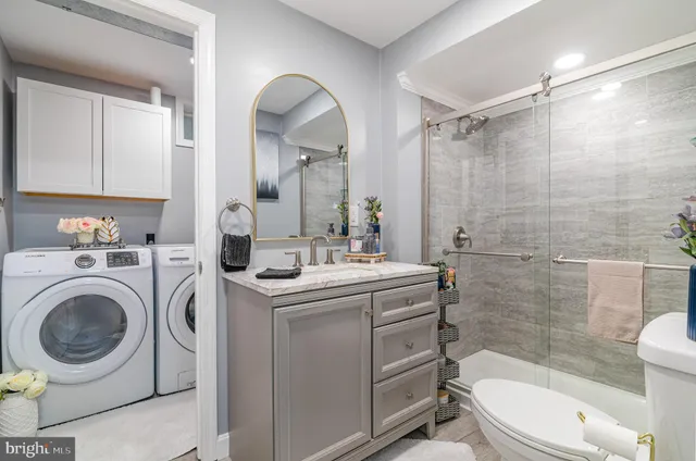 a bathroom with a sink a toilet and a shower