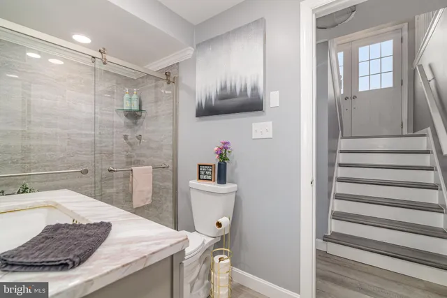 a bathroom with a sink a toilet and shower