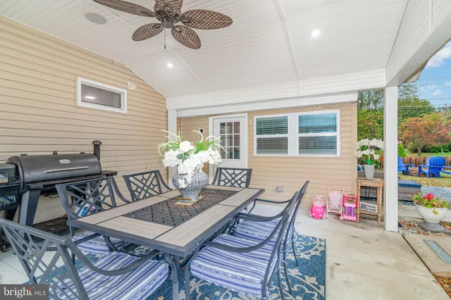 a view of a dining room with furniture and a potted plant