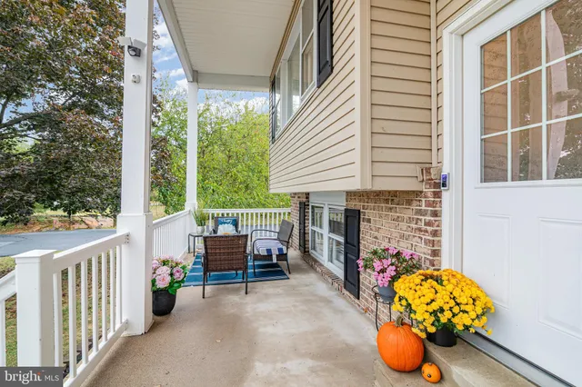 a view of a porch with chairs and a yard