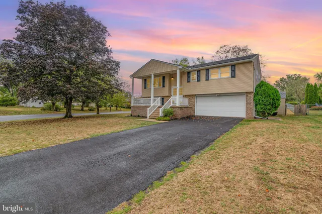 a view of house with outdoor space and sitting area