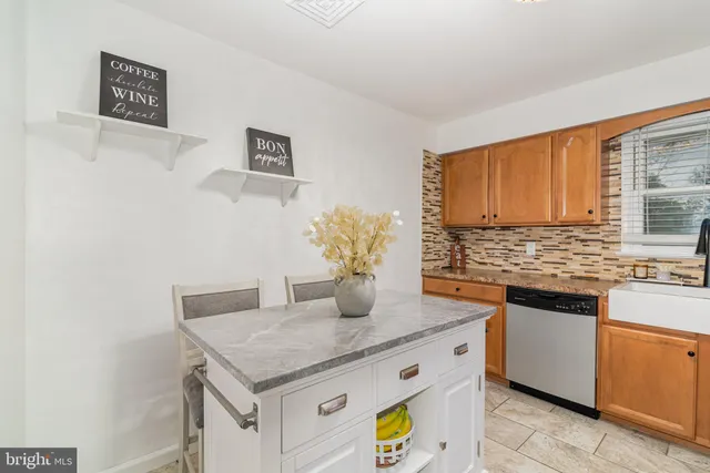 a kitchen with stainless steel appliances granite countertop a sink and a granite counter tops