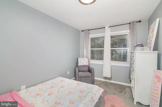 a bedroom with a bed and a table in it