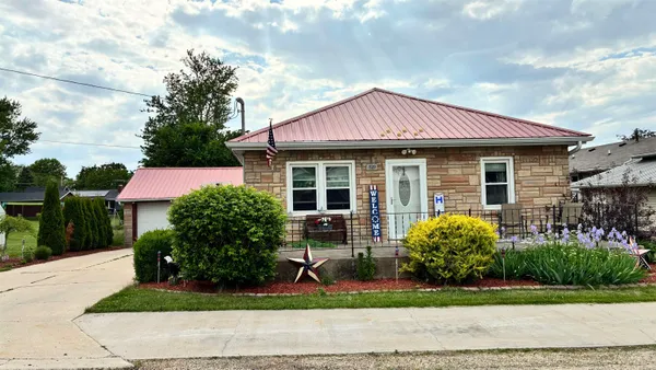 a front view of a house with garden