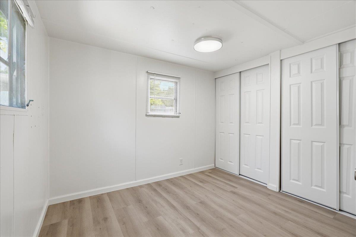 1525 Cold Springs Road, Unit 48 Placerville, CA 95667 - Photo 12 of 23 a view of an empty room with wooden floor and a window