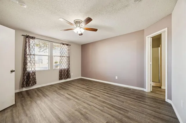a spacious bathroom with a tub sink and mirror