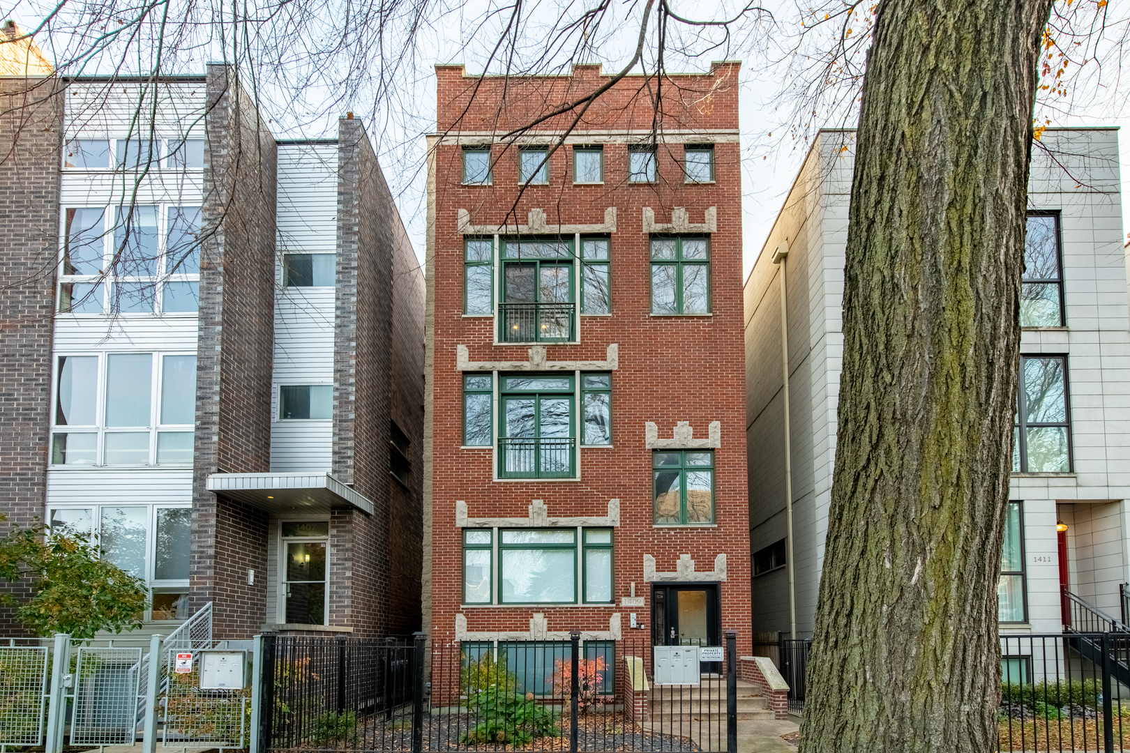 1409 West Huron Street, Unit 3 Chicago, IL 60642 - Photo 1 of 42 a view of a brick building next to a yard