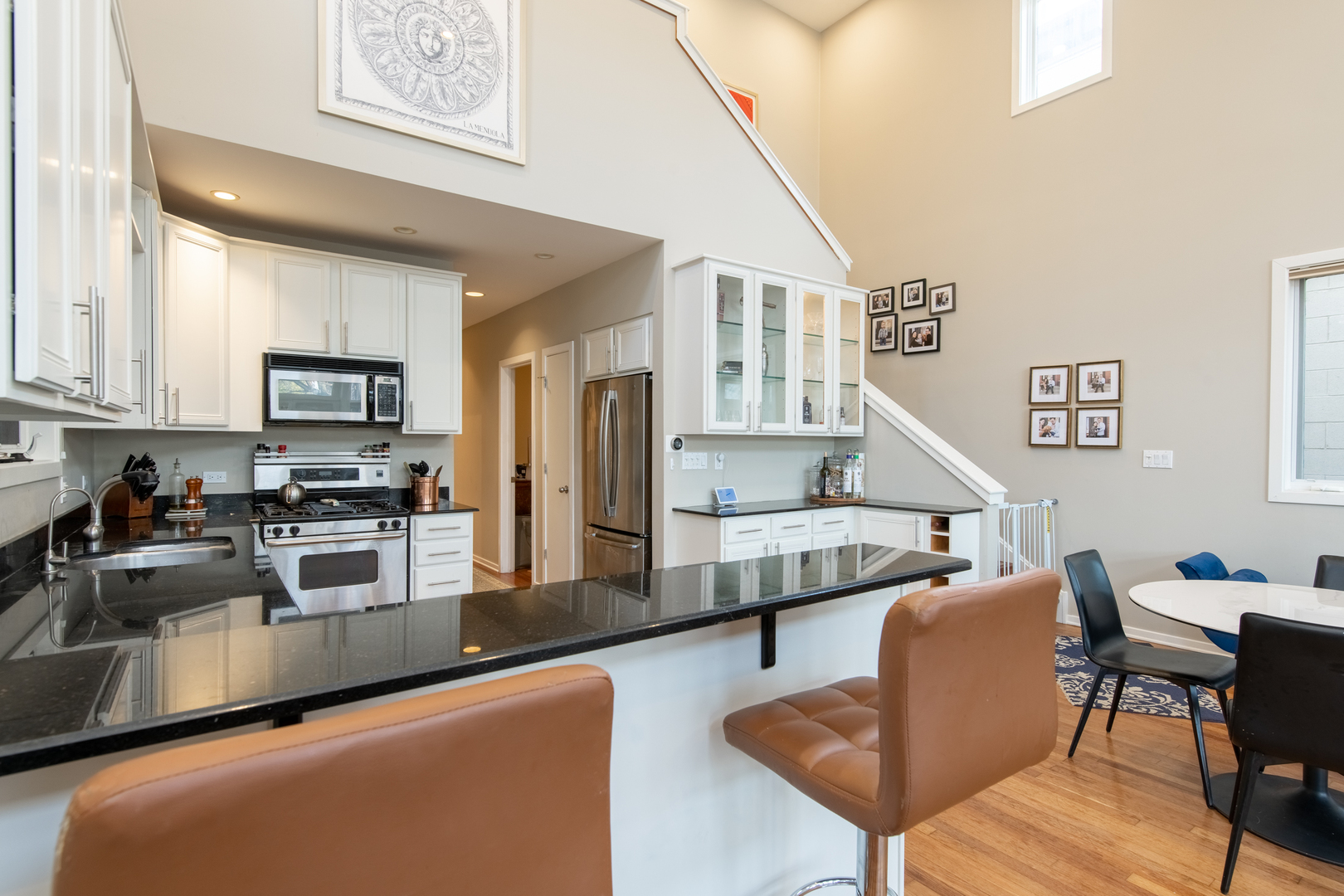 1409 West Huron Street, Unit 3 Chicago, IL 60642 - Photo 13 of 42 a kitchen with stainless steel appliances granite countertop a refrigerator a stove a sink dishwasher and white cabinets with wooden floor
