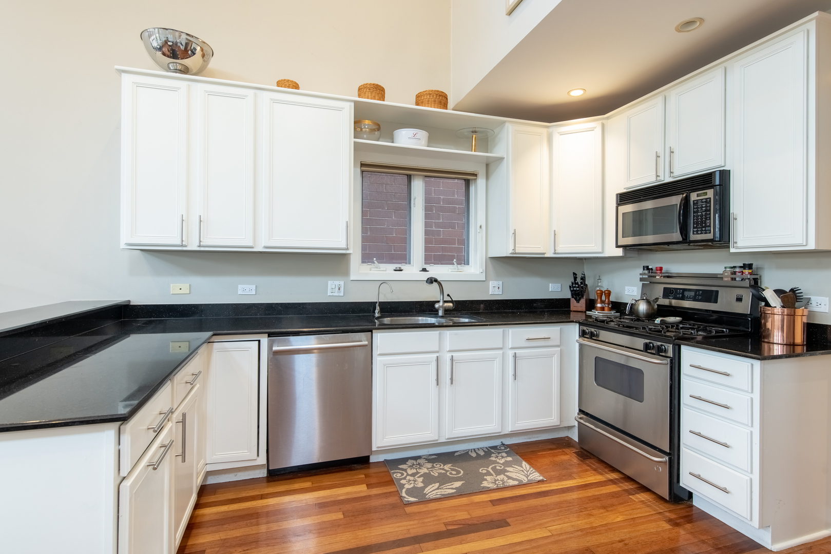 1409 West Huron Street, Unit 3 Chicago, IL 60642 - Photo 14 of 42 a kitchen with granite countertop a sink cabinets stainless steel appliances and a window