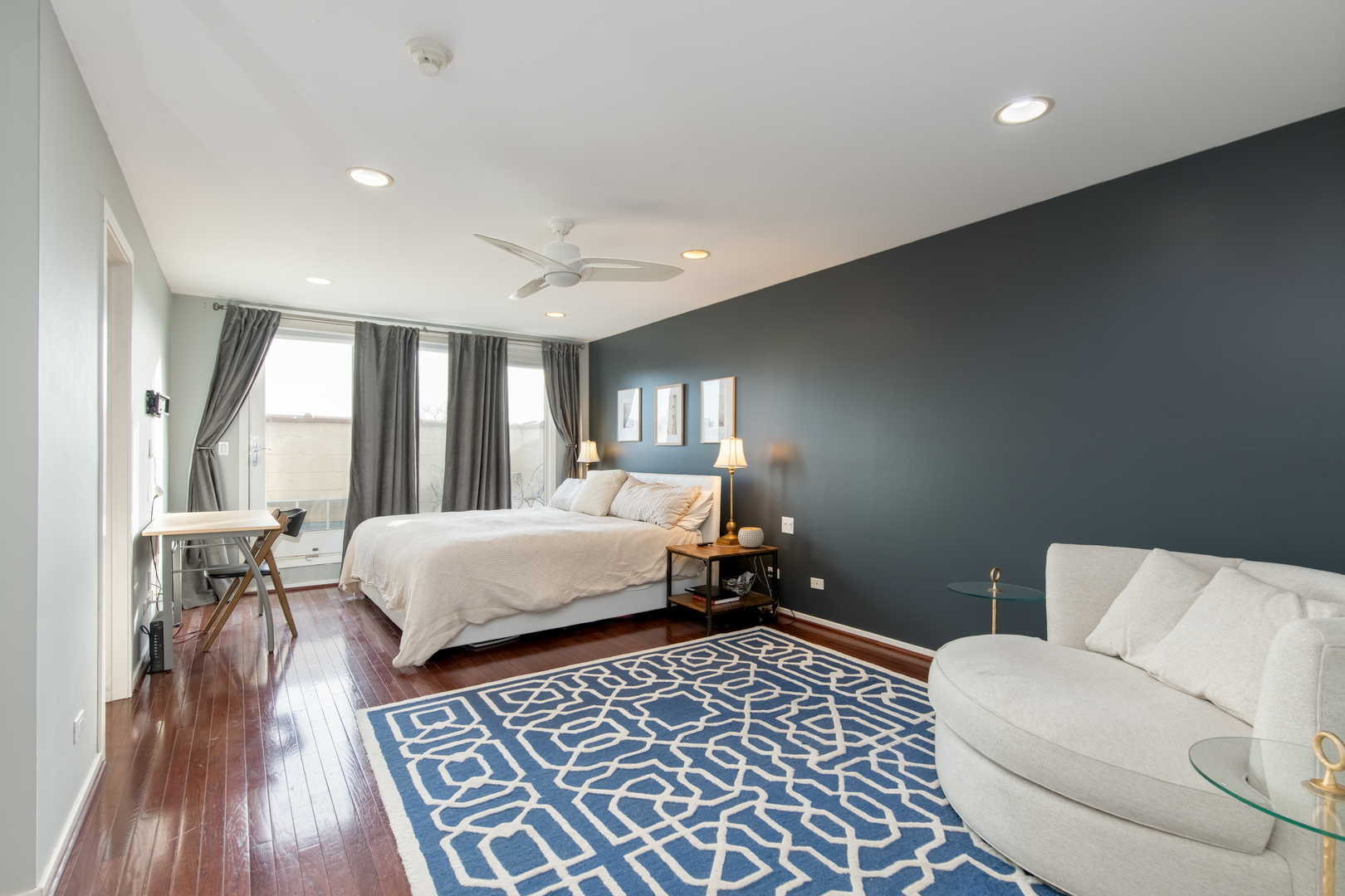 1409 West Huron Street, Unit 3 Chicago, IL 60642 - Photo 17 of 42 a bedroom with a large bed and a couch