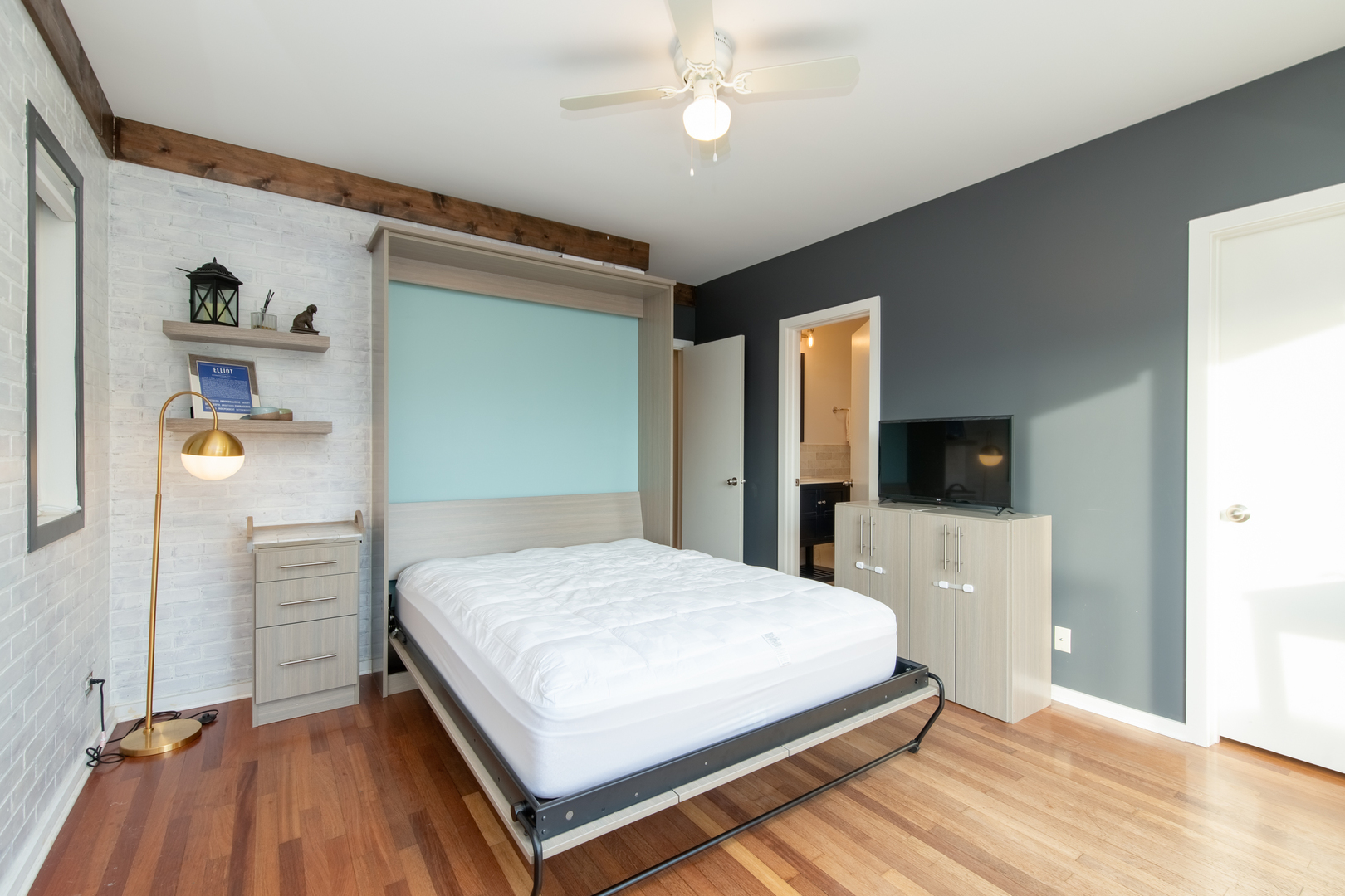 1409 West Huron Street, Unit 3 Chicago, IL 60642 - Photo 28 of 42 a bedroom with a bed and a flat screen tv