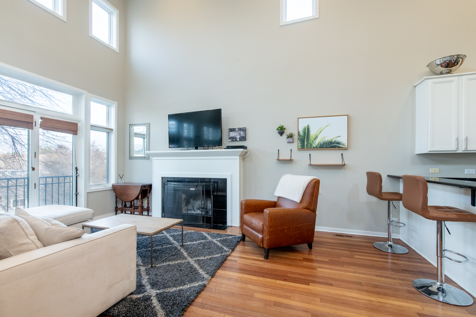 1409 West Huron Street, Unit 3 Chicago, IL 60642 - Photo 5 of 42 a living room with furniture a flat screen tv and a fireplace