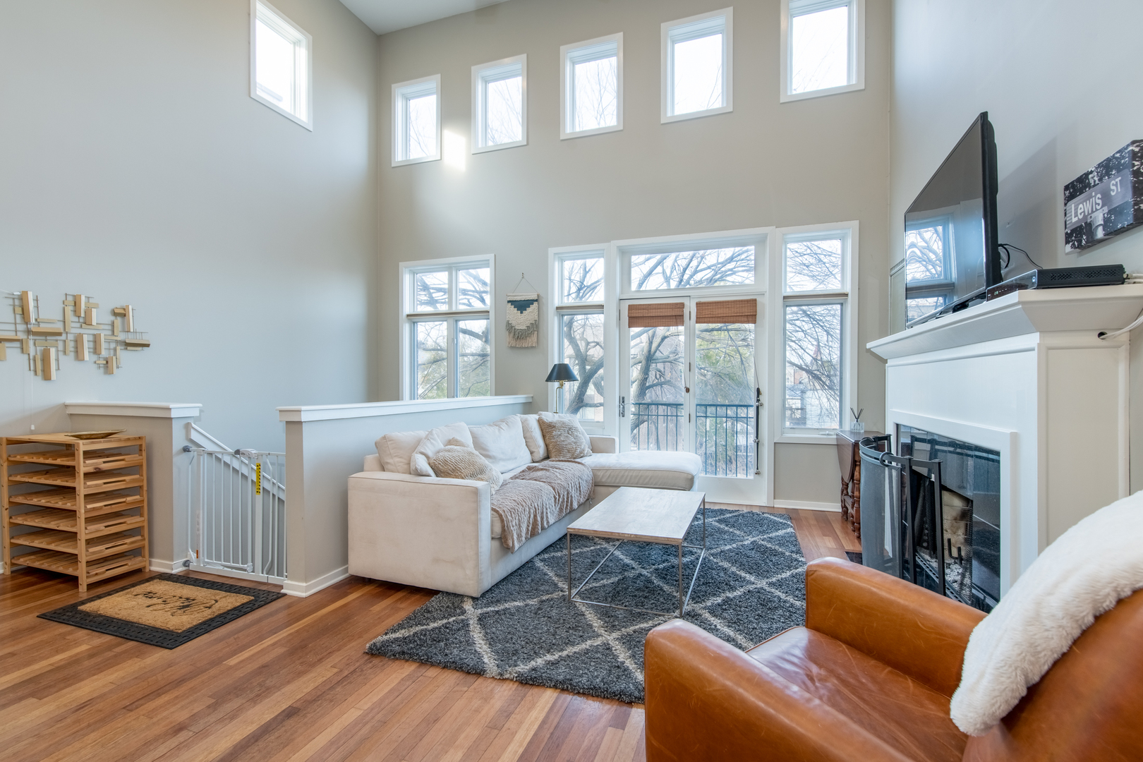 1409 West Huron Street, Unit 3 Chicago, IL 60642 - Photo 6 of 42 a living room with furniture a fireplace and a floor to ceiling window