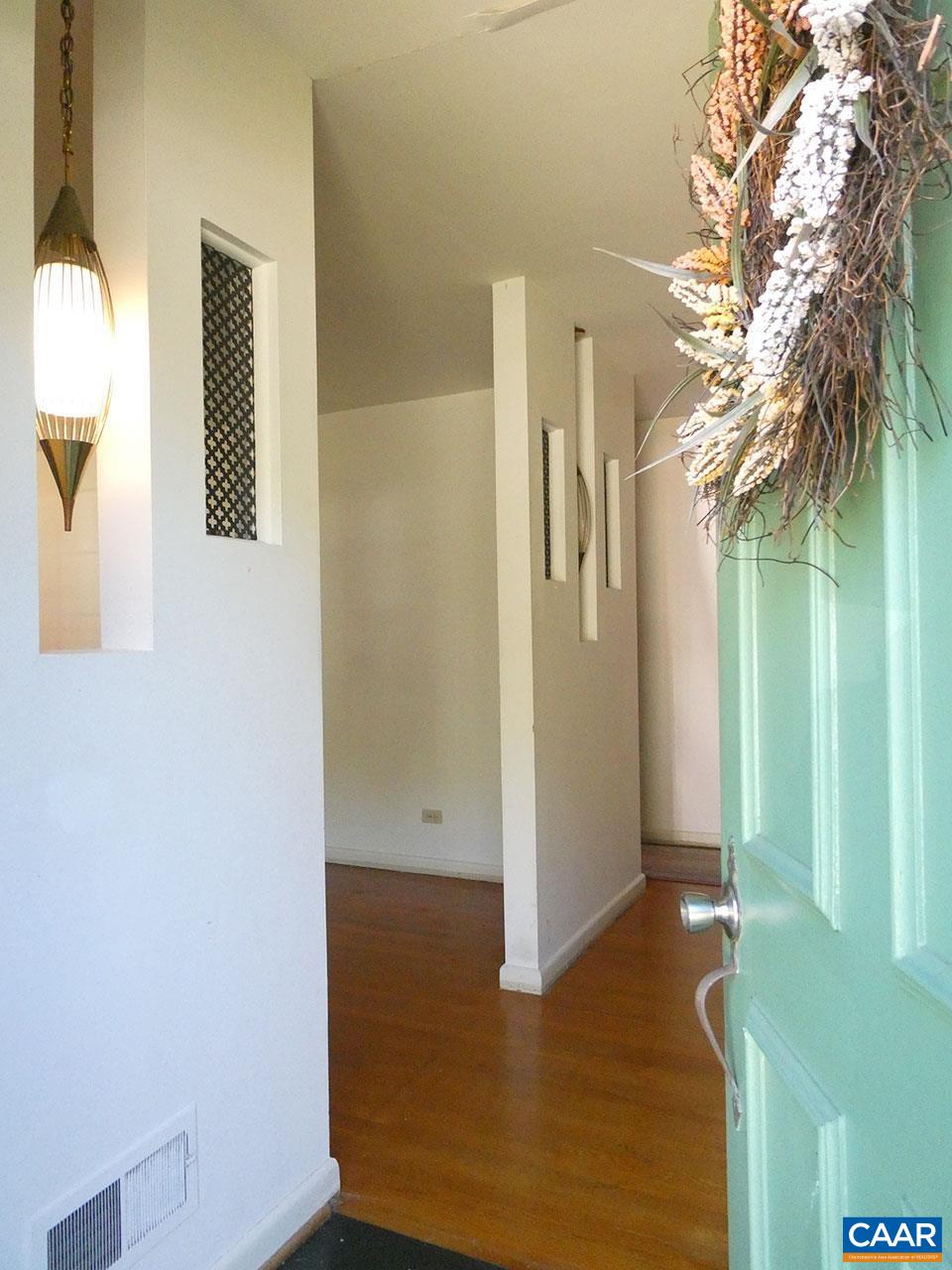106 Elkhorn Road Charlottesville, VA 22903 - Photo 2 of 27 a view of a hallway with wooden floor and a bathroom