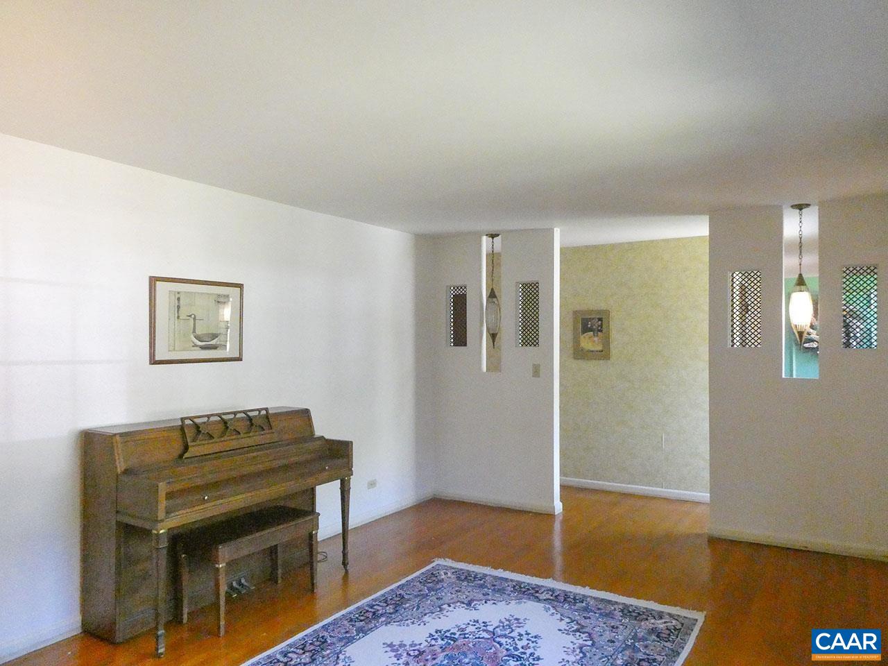 106 Elkhorn Road Charlottesville, VA 22903 - Photo 5 of 27 a view of a livingroom with a piano and wooden floor