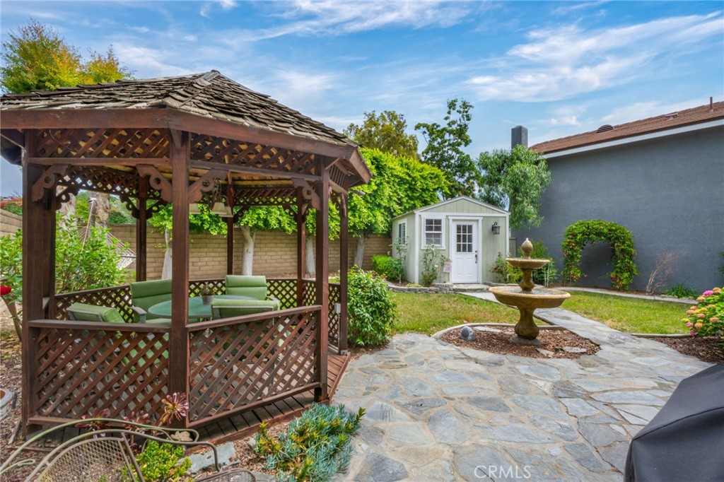 109 Cinnamon Ridge Road Brea, CA 92821 - Photo 53 of 67 Back yard gazebo, paved stone walkway to cottage with electricity connected, back lawn, trees and cinder block fencing