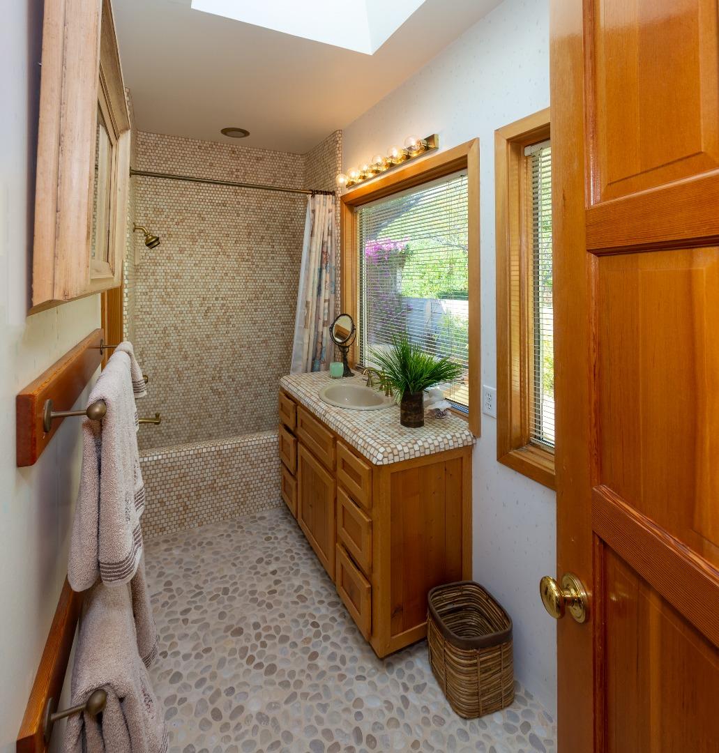 343 Beach Drive Aptos, CA 95003 - Photo 20 of 34 a bathroom with a tub sink and mirror