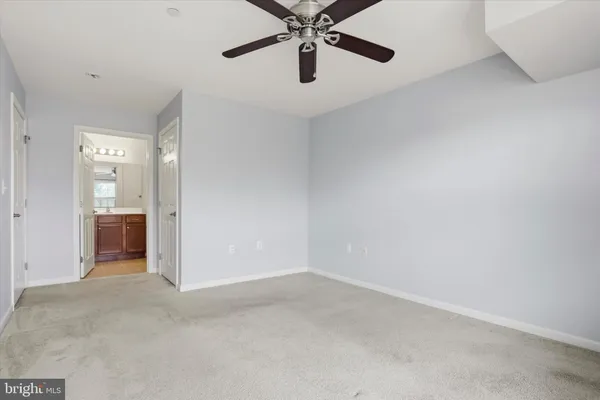 a view of a room with a ceiling fan