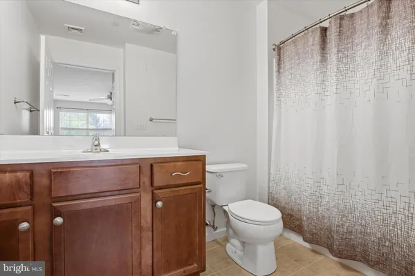 a bathroom with a toilet a sink and a mirror