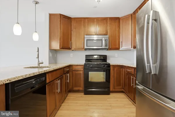 a kitchen with a sink appliances and cabinets