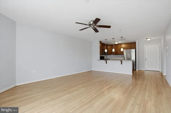 a view of a big room with wooden floor and windows