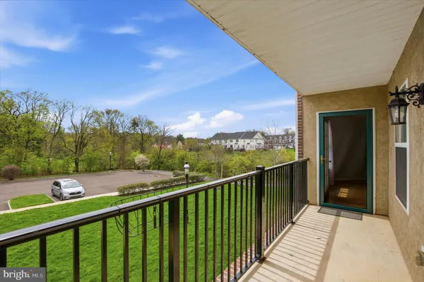 a view of a balcony with wooden floor and fence