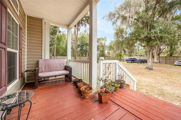 a view of a balcony with chairs and wooden floor
