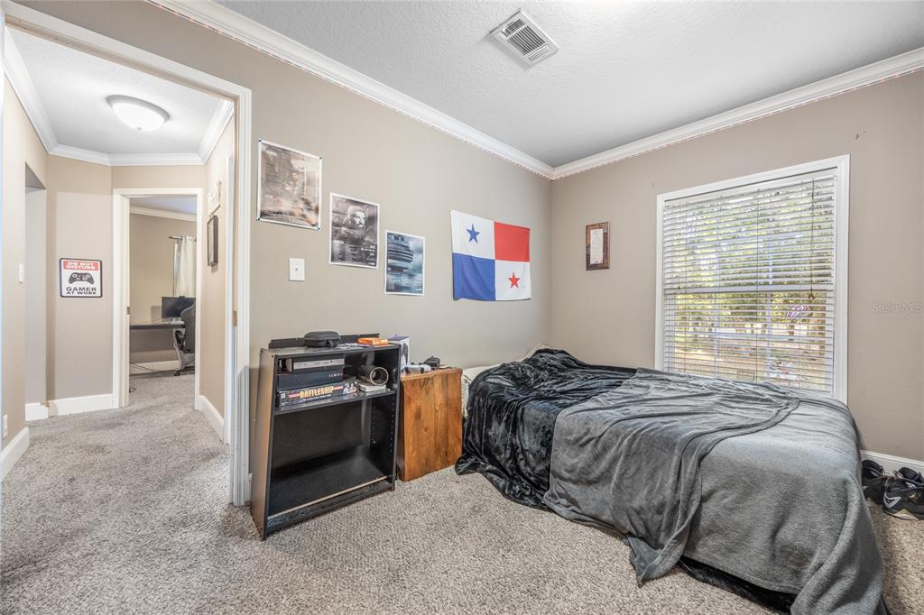 1085 State Rte 100 Florahome, FL 32140 - Photo 34 of 52 a bedroom with a bed and a stove