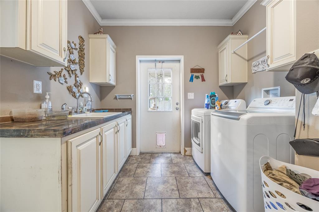 1085 State Rte 100 Florahome, FL 32140 - Photo 37 of 52 a kitchen with a sink stove and refrigerator