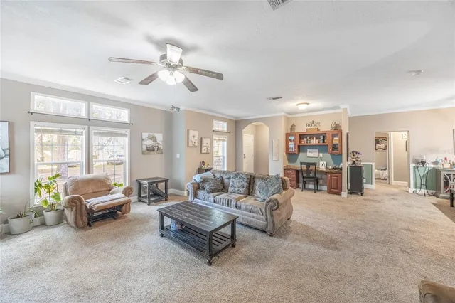 a kitchen with stainless steel appliances granite countertop a refrigerator a sink dishwasher a stove and white cabinets with wooden floor